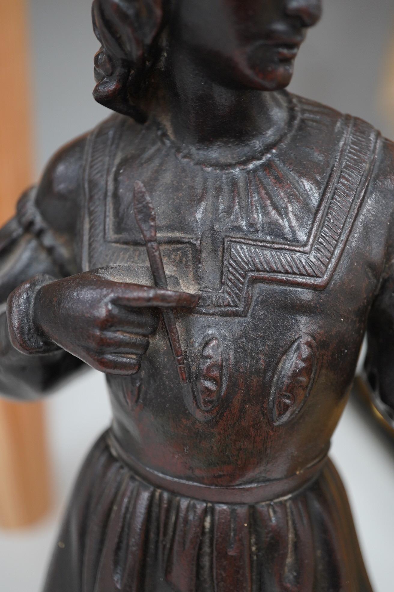 A cast iron figure of a scribe, with bronzed patina, 33cm high. Condition - good